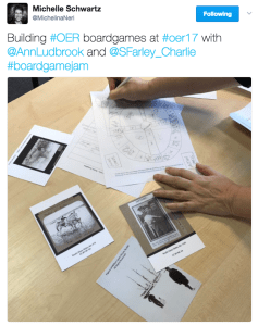 Picture of postcards with collections images, and a hand drawn board design for a game. Text reads: Building #OER boardgames at #oer17 with @AnnLudbrook and @Sfarley_Charlie #boardgamejam